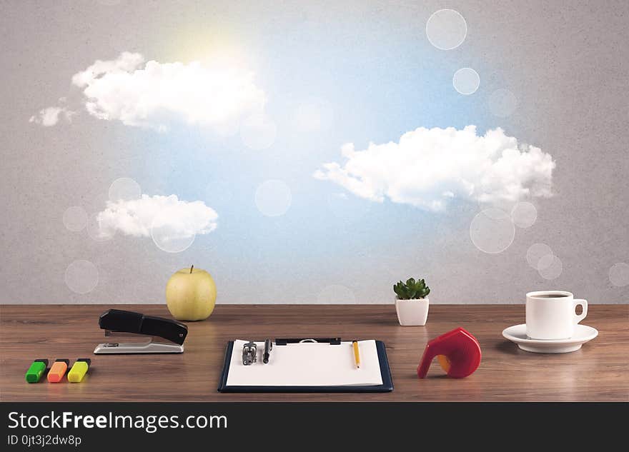 Close up of business office desk concept with clouds, blue sky and sunshine. Close up of business office desk concept with clouds, blue sky and sunshine