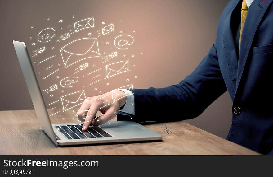 An office worker sending emails and communication with clients with the help of a portable laptop on desk concept. An office worker sending emails and communication with clients with the help of a portable laptop on desk concept