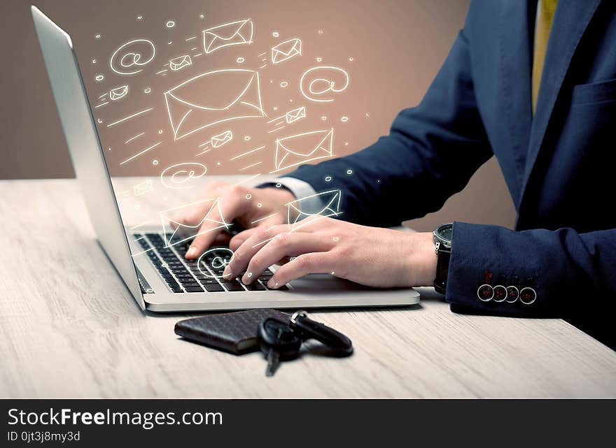 An office worker sending emails and communication with clients with the help of a portable laptop on desk concept. An office worker sending emails and communication with clients with the help of a portable laptop on desk concept