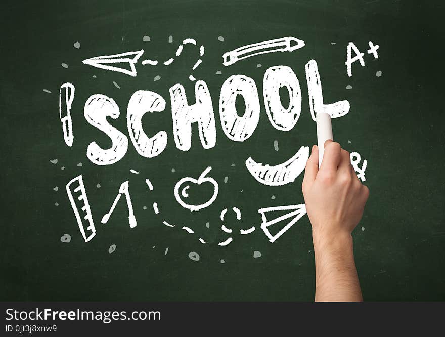 A teacher writing school, drawing children things on clean green chalkboard by hand. A teacher writing school, drawing children things on clean green chalkboard by hand