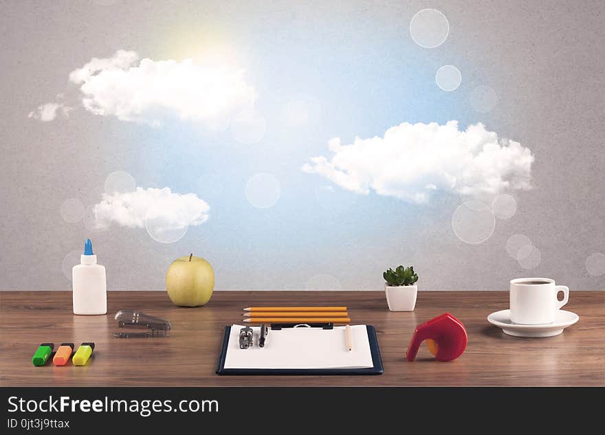 Bright sky with clouds and office desk