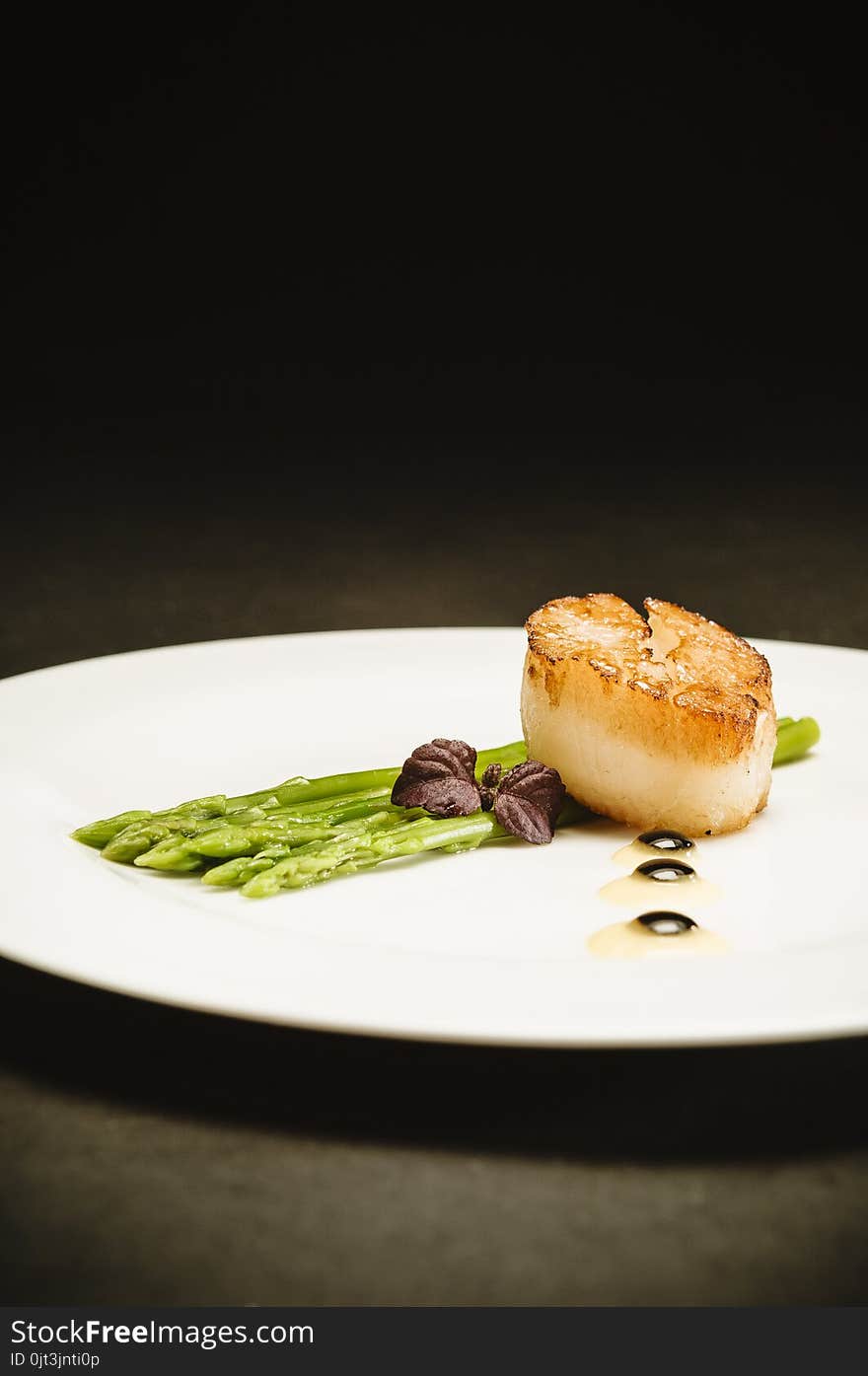 Scallop With Green Asparagus On White Plate