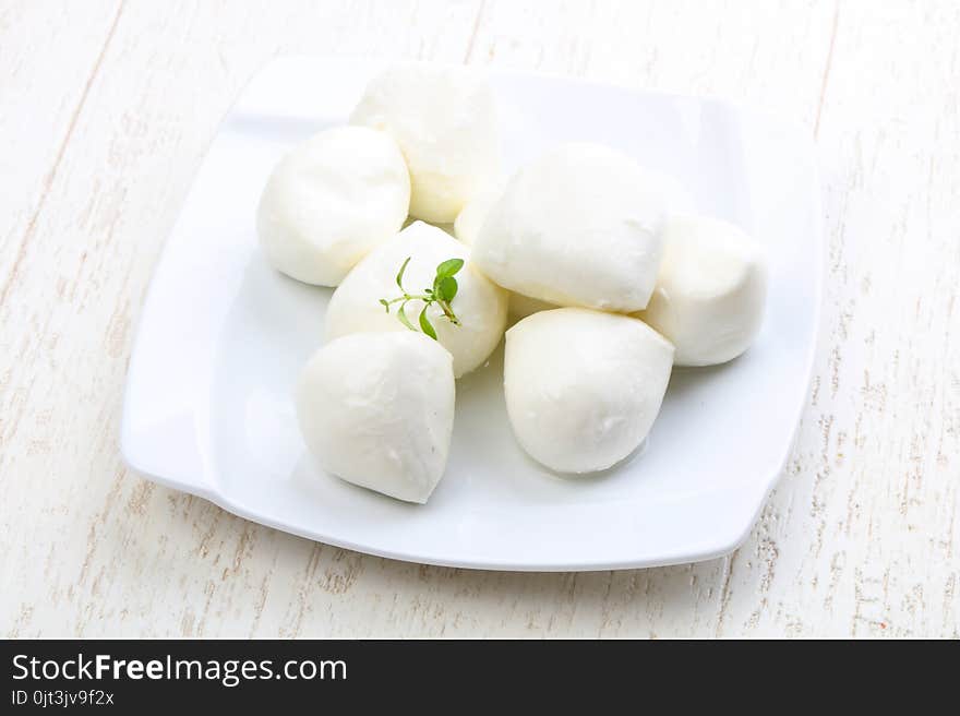 Mozzarella cheese with thyme branch on the white background