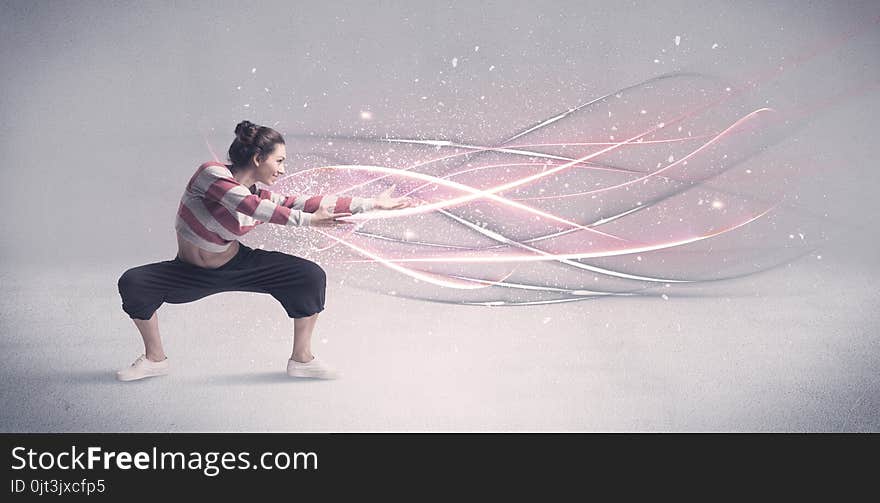 A pretty hip hop dancer dancing contemporary dance illustrated with glowing motion lines in the background concept. A pretty hip hop dancer dancing contemporary dance illustrated with glowing motion lines in the background concept.