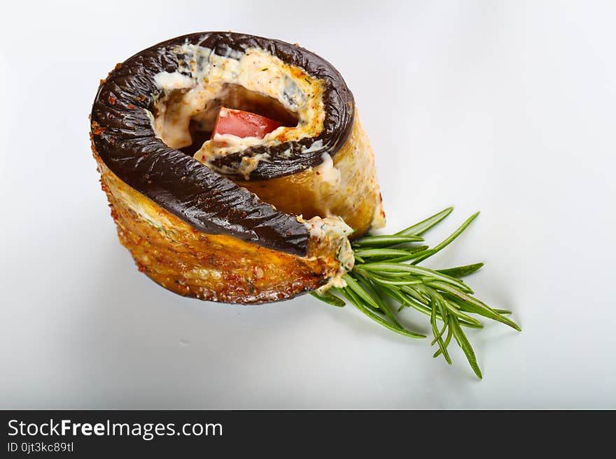 Stuffed eggplant with tomato and rosemary branch