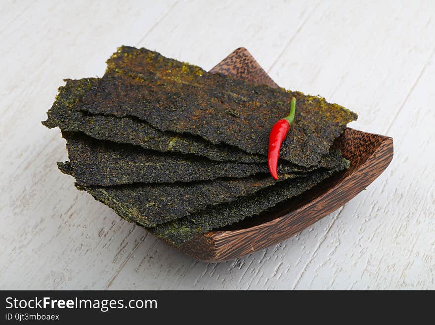 Spicy Nori seaweed sheets with pepper on wood