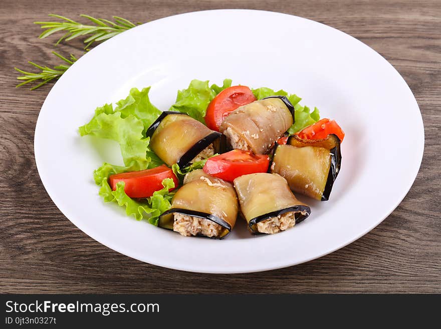 Eggplant rolls with walnuts, chicken and tomato