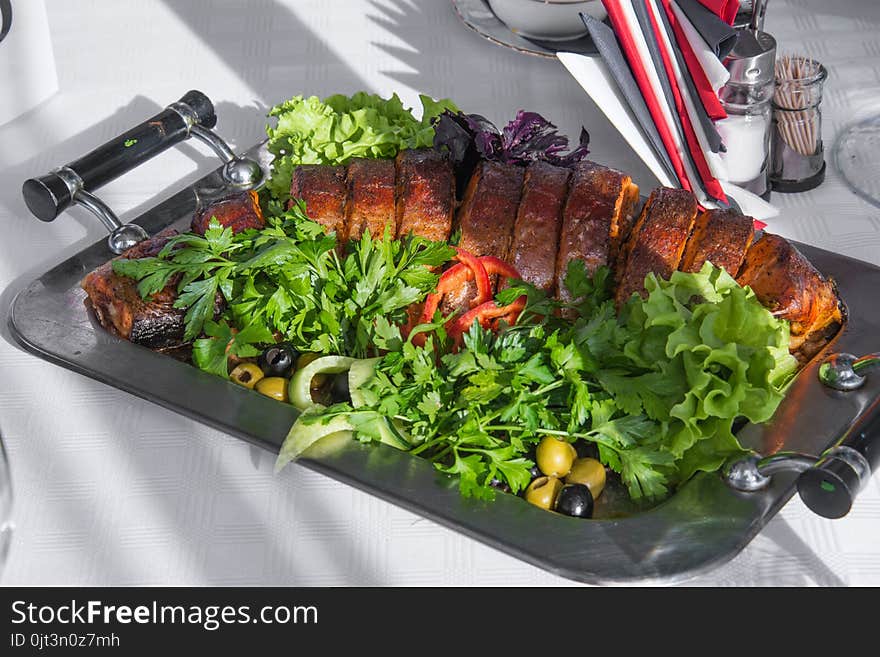 Delicious celebration dish with parsley and olives on metal tray. Delicious celebration dish with parsley and olives on metal tray