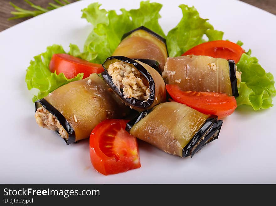 Eggplant rolls with walnuts, chicken and tomato