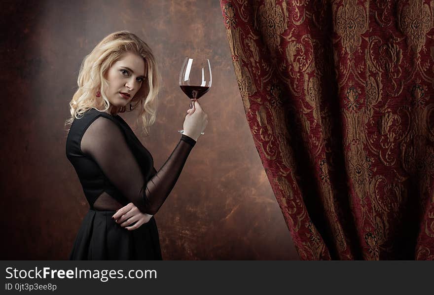 Portrait Of Beautiful Young Woman With Red Wine.