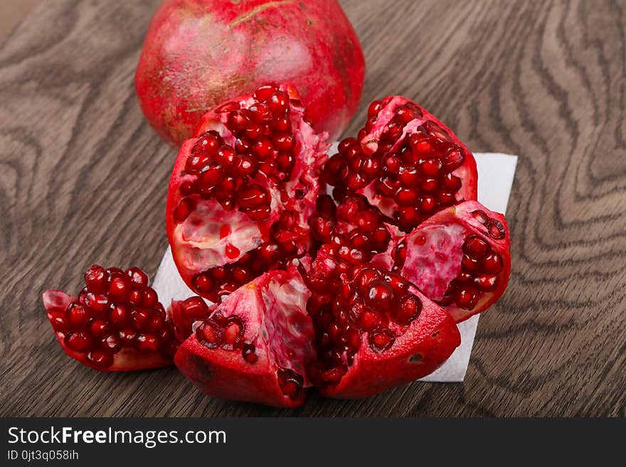 Fresh sweet ripe Pomegranate fruit on the wood background