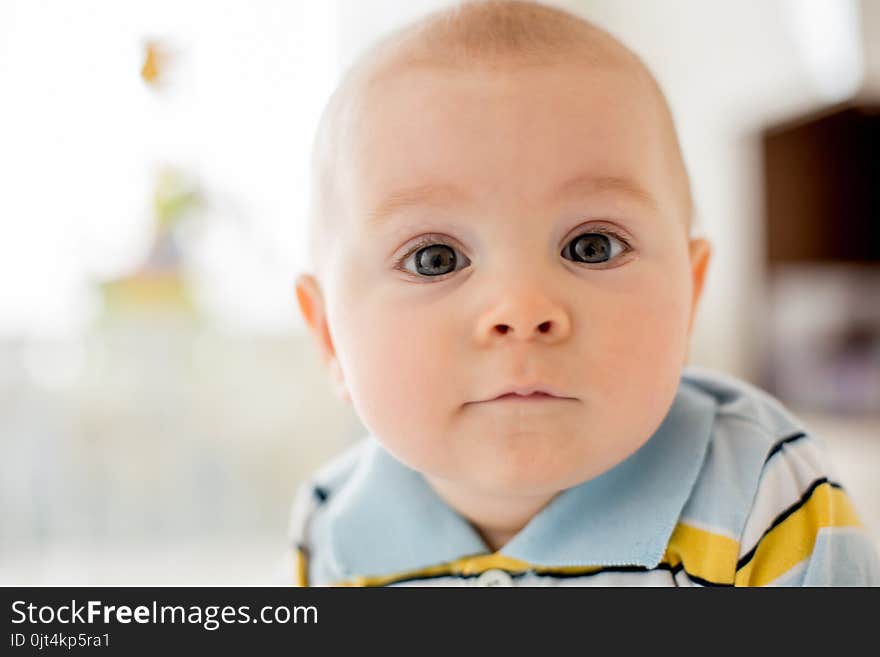 Portrait of a cute smiling infant baby boy. Happy childhood concept.