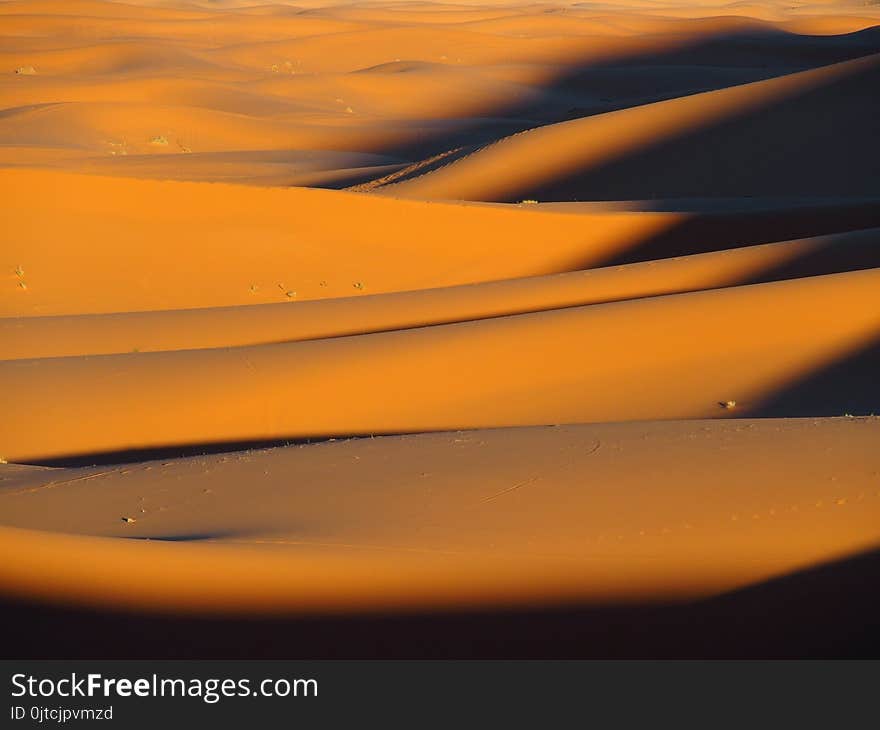 ERG CHEBBI dunes range near MERZOUGA city with landscapes of sandy desert formations in southeastern MOROCCO near border with ALGIERIA in 2017 warm sunny winter day, Africa on February. ERG CHEBBI dunes range near MERZOUGA city with landscapes of sandy desert formations in southeastern MOROCCO near border with ALGIERIA in 2017 warm sunny winter day, Africa on February.