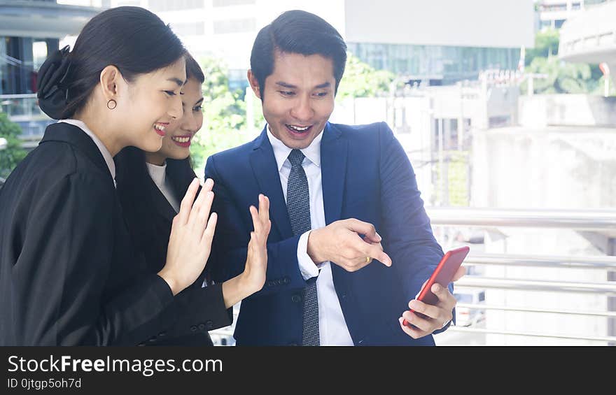 Group smart business people of men and women talk together and video call yourself in feeling happy with tablet smart phone device at the outdoor pedestrian walkway space in the morning. Group smart business people of men and women talk together and video call yourself in feeling happy with tablet smart phone device at the outdoor pedestrian walkway space in the morning.