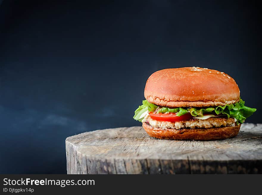 Appetizing chickenburger on a wooden table