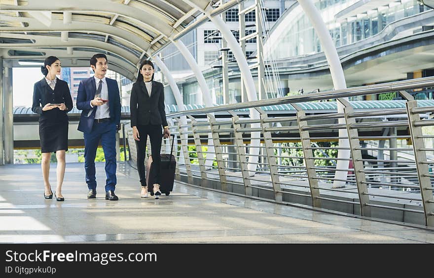 Business people walk outdoor pedestrian walkway