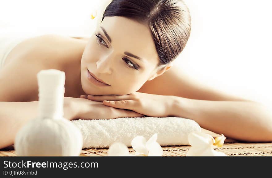 Portrait of a woman in spa. Massage healing procedure.