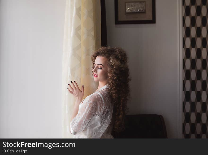 Happy Girl Standing By The Window