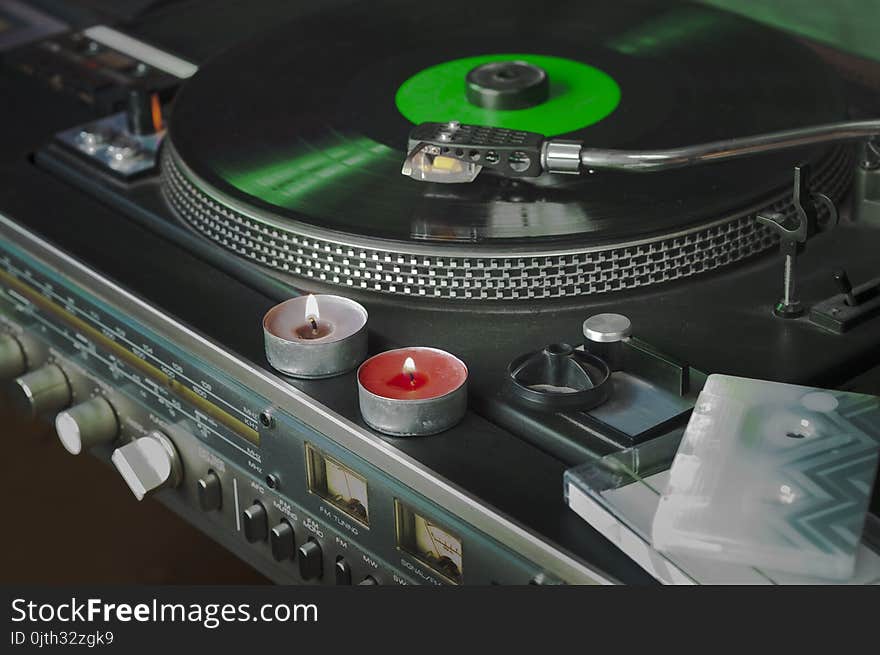 Vintage vinyl stereo player with candles on a top, indoor closeup. Vintage vinyl stereo player with candles on a top, indoor closeup