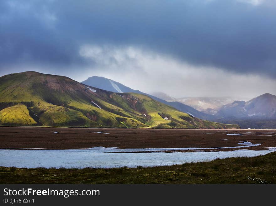 Beautiful Icelandic landscape. Green volcanic mountains in cloudy weather. Beautiful Icelandic landscape. Green volcanic mountains in cloudy weather.