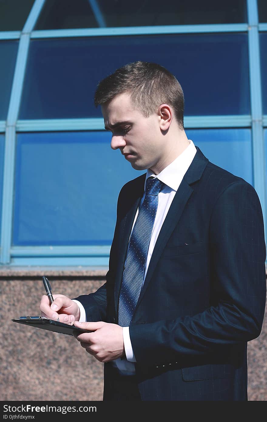 Thoughtful businessman standing in the lobby of a spacious office.