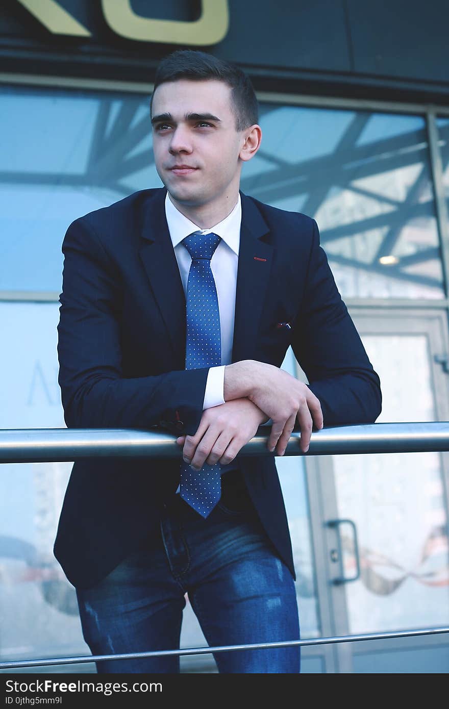 Close up.young businessman standing on balcony in office