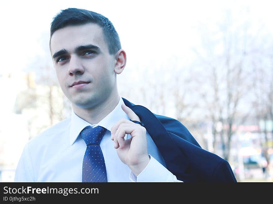 Close up.young businessman standing in modern city.