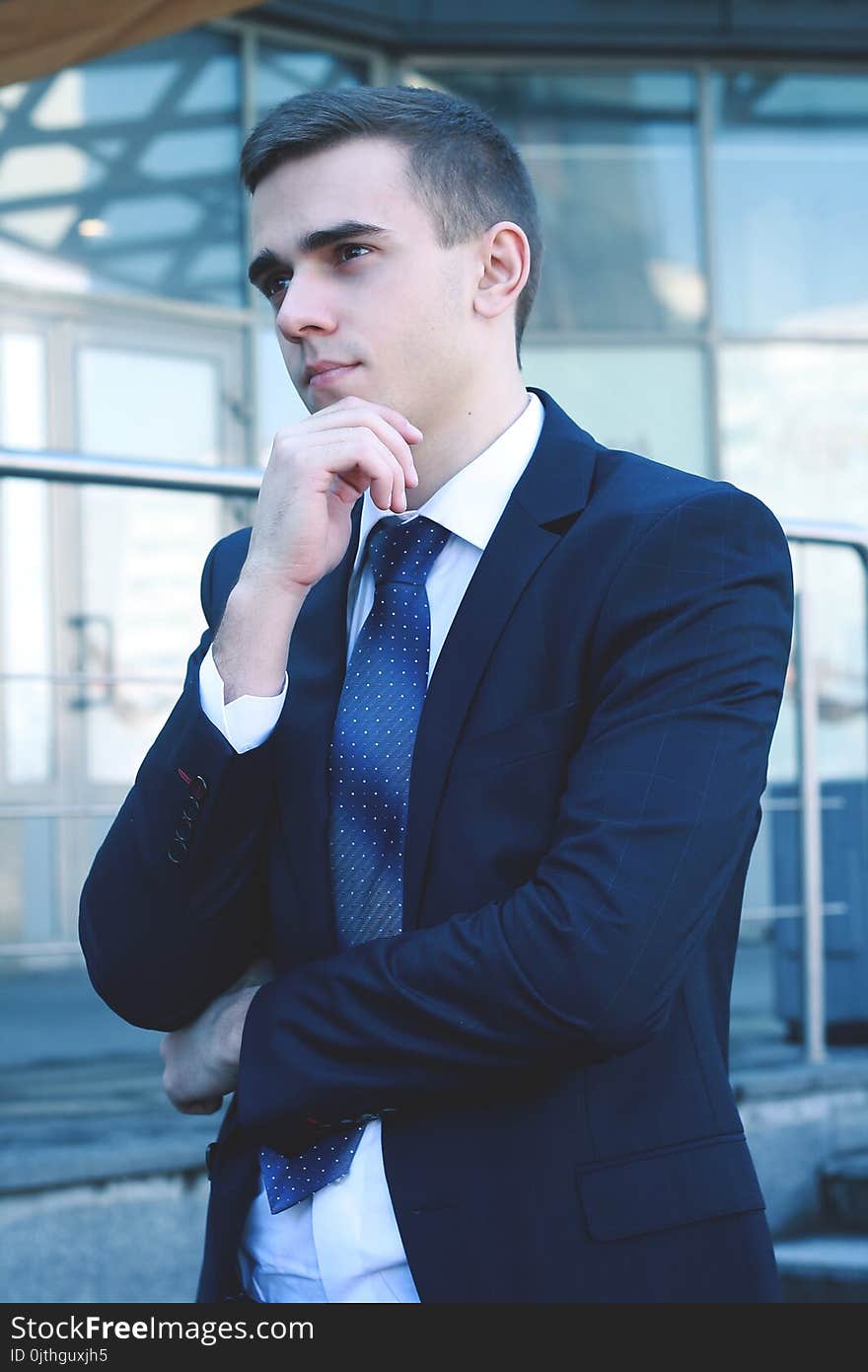 Close up.pensive businessman on background of office building.