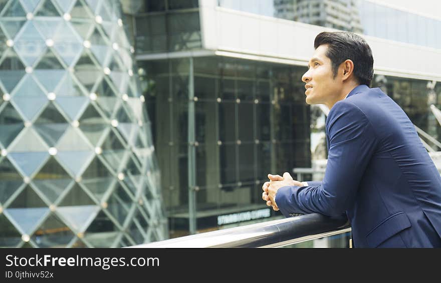 Business man stand with feeling confident and freedom at outdoor