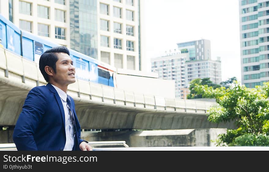 Business man stand with feeling confident and freedom at outdoor