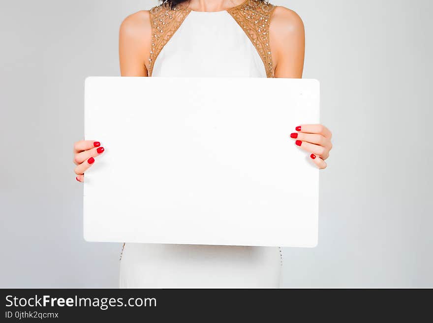 A sheet of white paper, a card in beautiful female hands