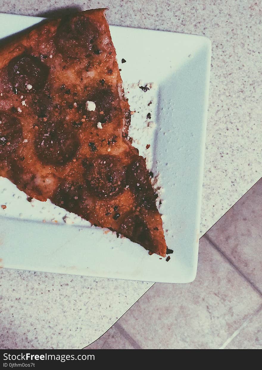 Slice of Pizza on White Ceramic Plate