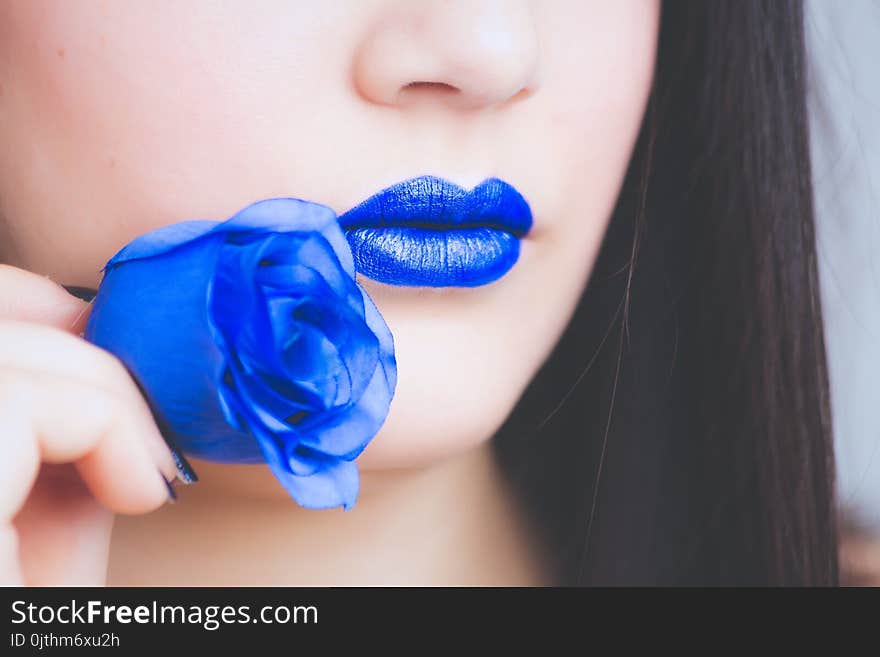 Woman in Blue Lipstick Holding Blue Rose Flower