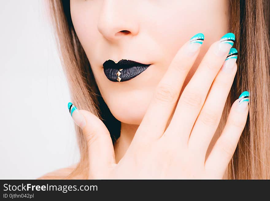 Woman With Black Lipstick and Teal Nail Polish