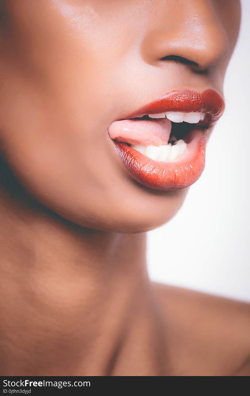 Selective Focus Photograph of Woman Sticking Her Tongue Out