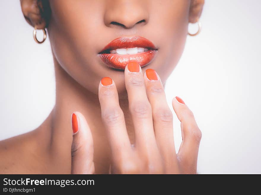 Woman With Orange Manicure