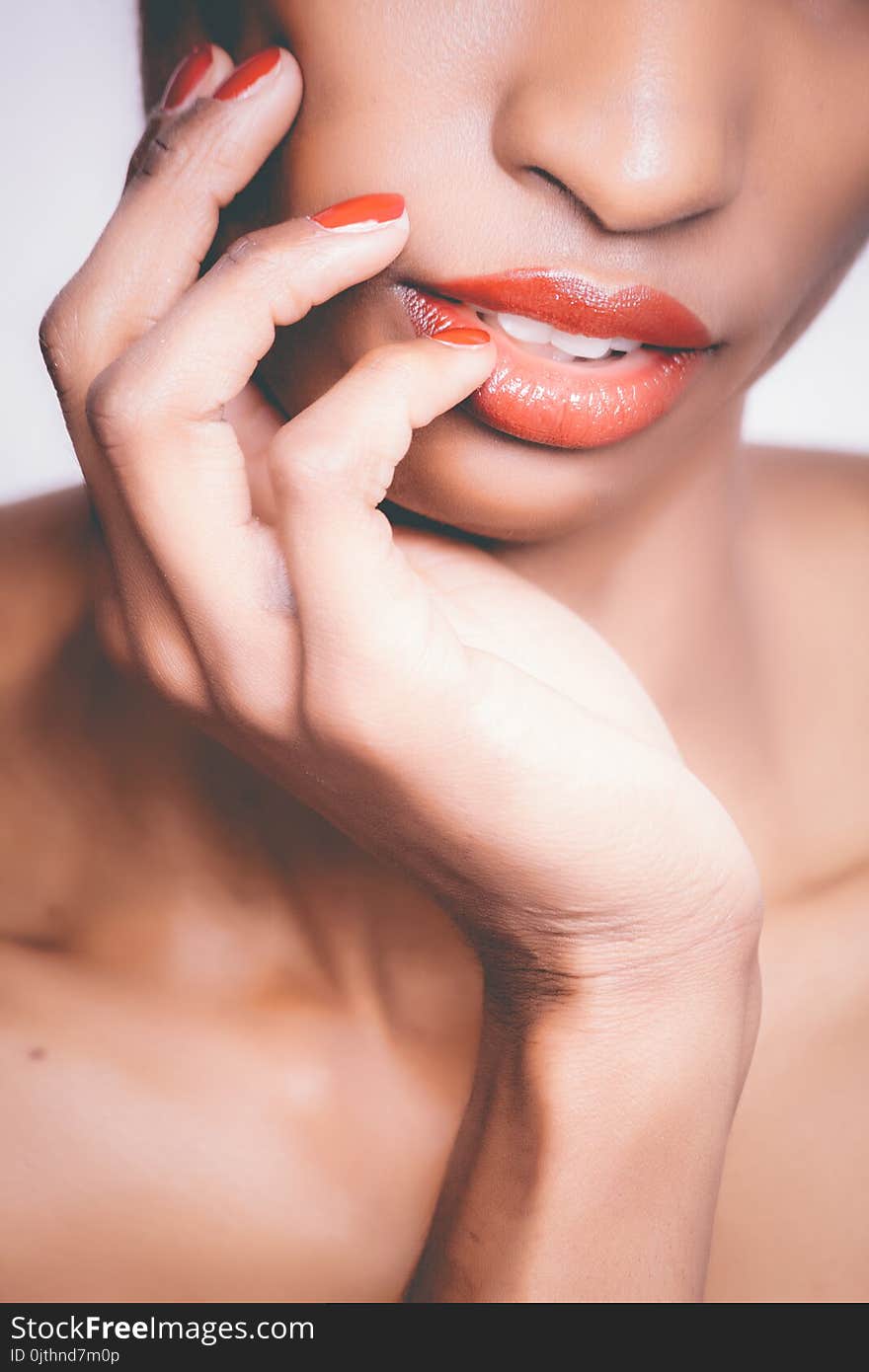 Woman With Orange Lipstick and Manicure Taking Selfie