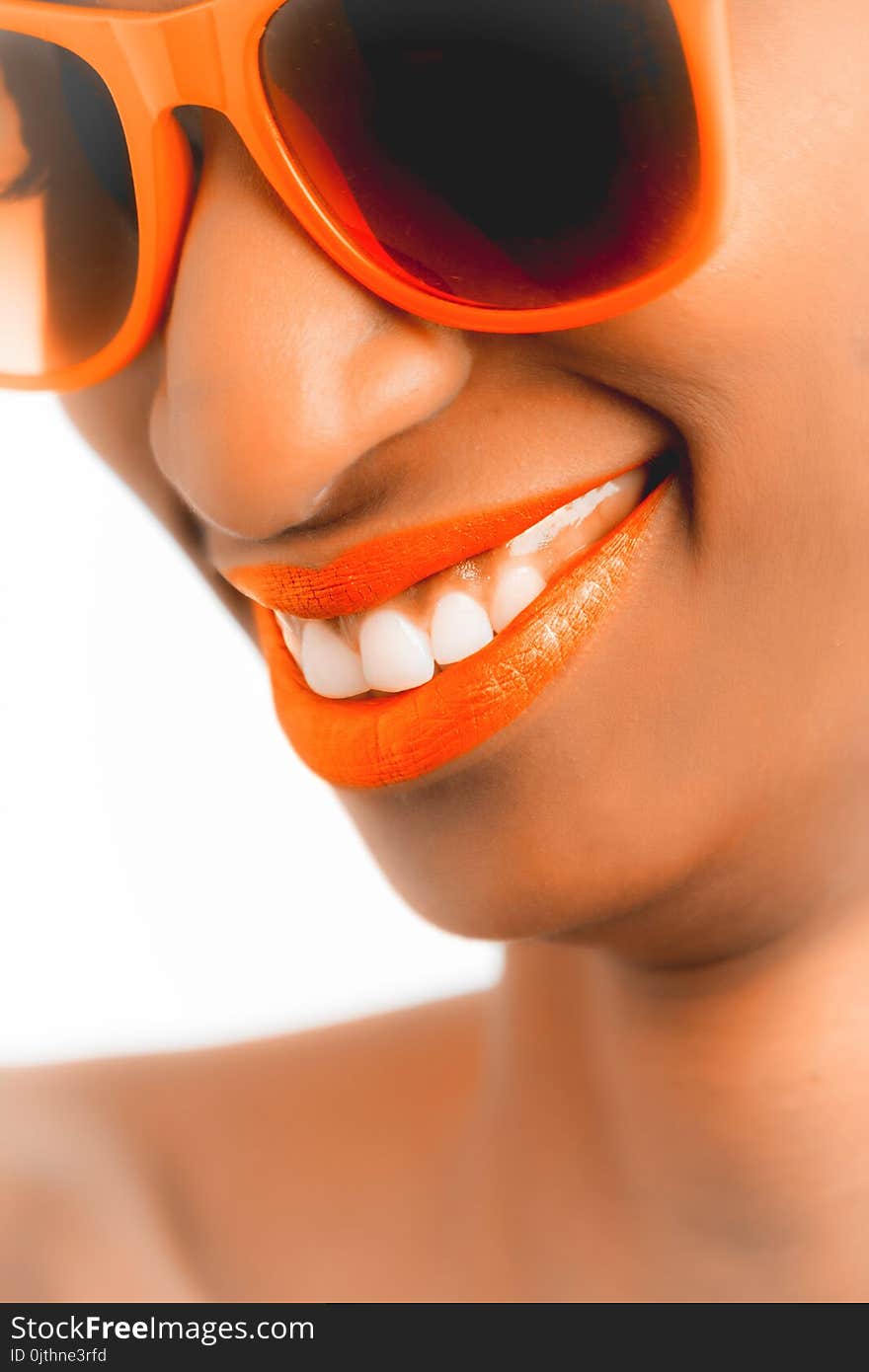 Woman Wearing Orange Frame Sunglasses and Orange Lipstick