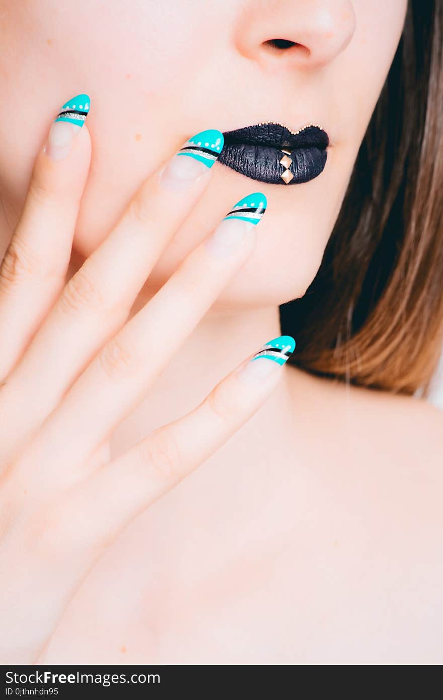 Woman With Black Lipstick and Teal Manicure