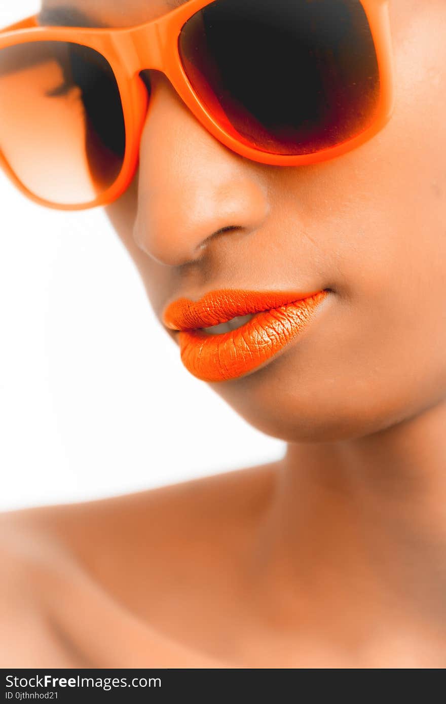 Closeup and Selective Focus Photograph of Woman Wearing Orange-framed Wayfarer-style Sunglasses