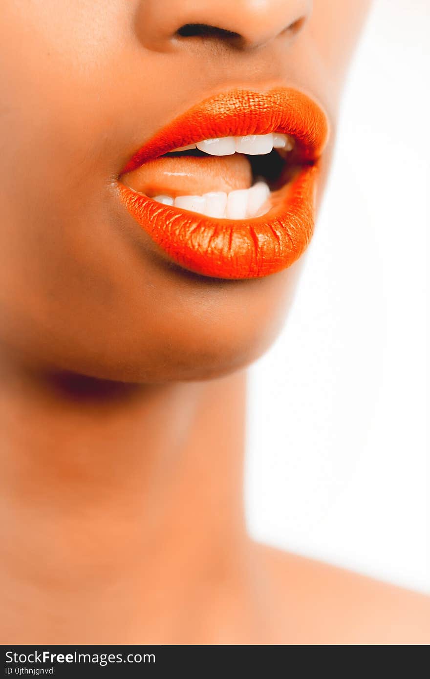 Selective Focus Photography of Woman With Orange Lipstick