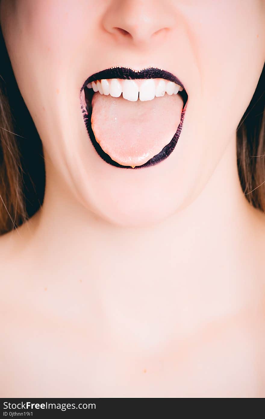 Woman Wearing Black Lipstick Tongue Out Photo