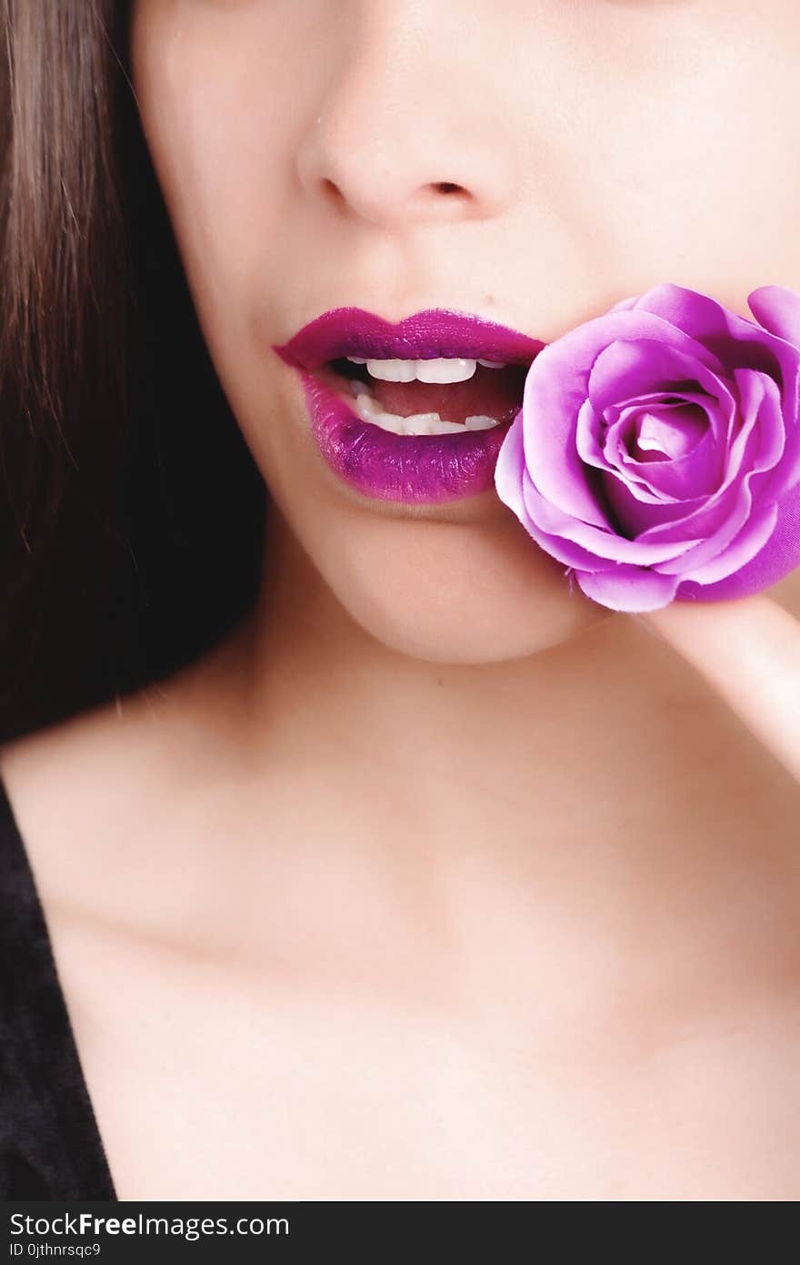 Woman Wearing Black Top Holding Purple Rose Flower