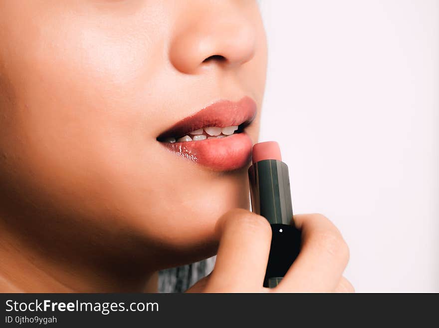 Woman Using Pink Lipstick