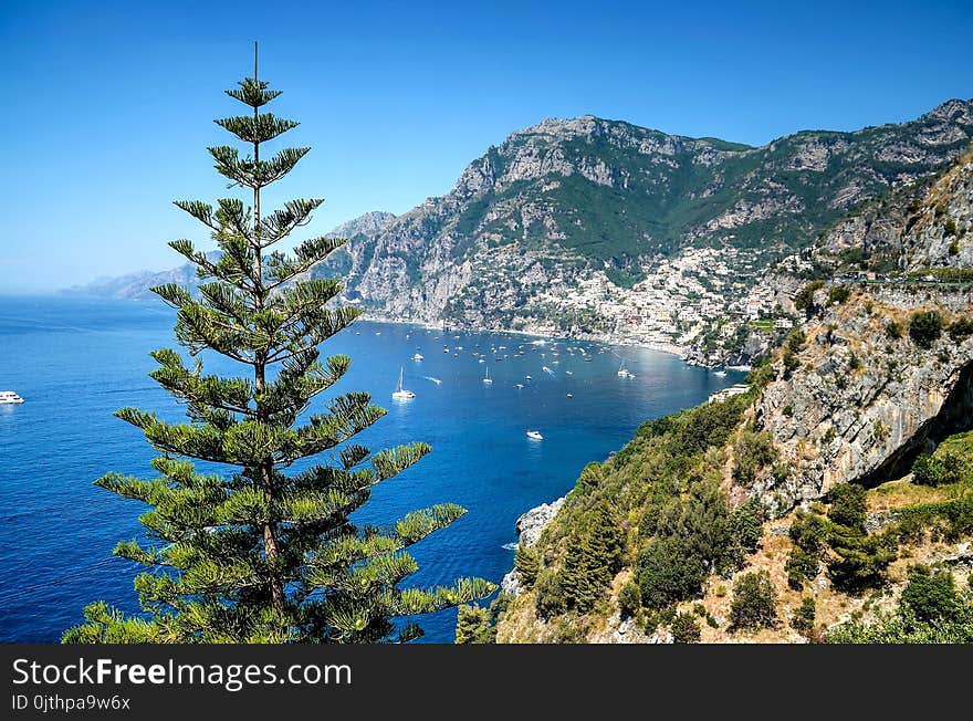 Body of Water Surrounded by Mountain