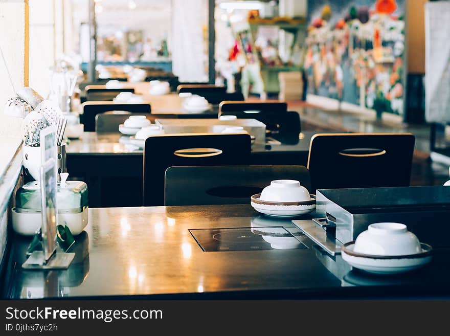 Table setting and electric stove in restaurant. Table setting and electric stove in restaurant.