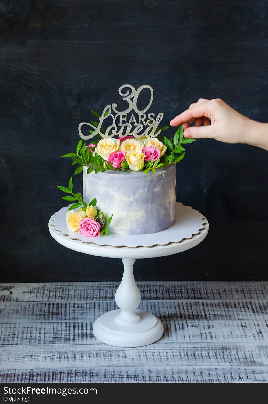 30th anniversary cake with roses and greenery on a cake stand. 30th anniversary cake with roses and greenery on a cake stand