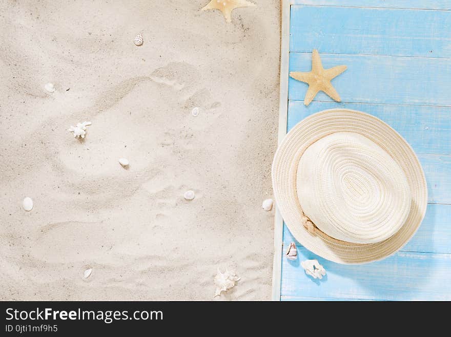 Top view straw hat with copy space. Traveler accessories on sand. Travel vacation concept. Summer background. Top view straw hat with copy space. Traveler accessories on sand. Travel vacation concept. Summer background