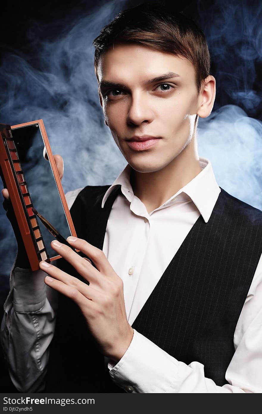 Young Male Make Up Artist Holding Shadow Palette And Brush.