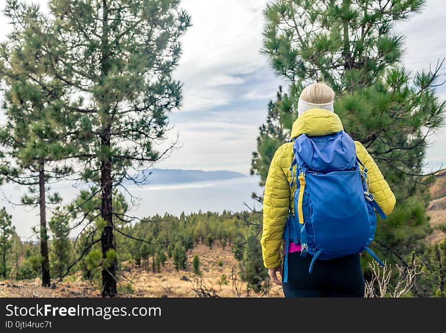 Hiking woman with backpack looking at inspirational mountains la